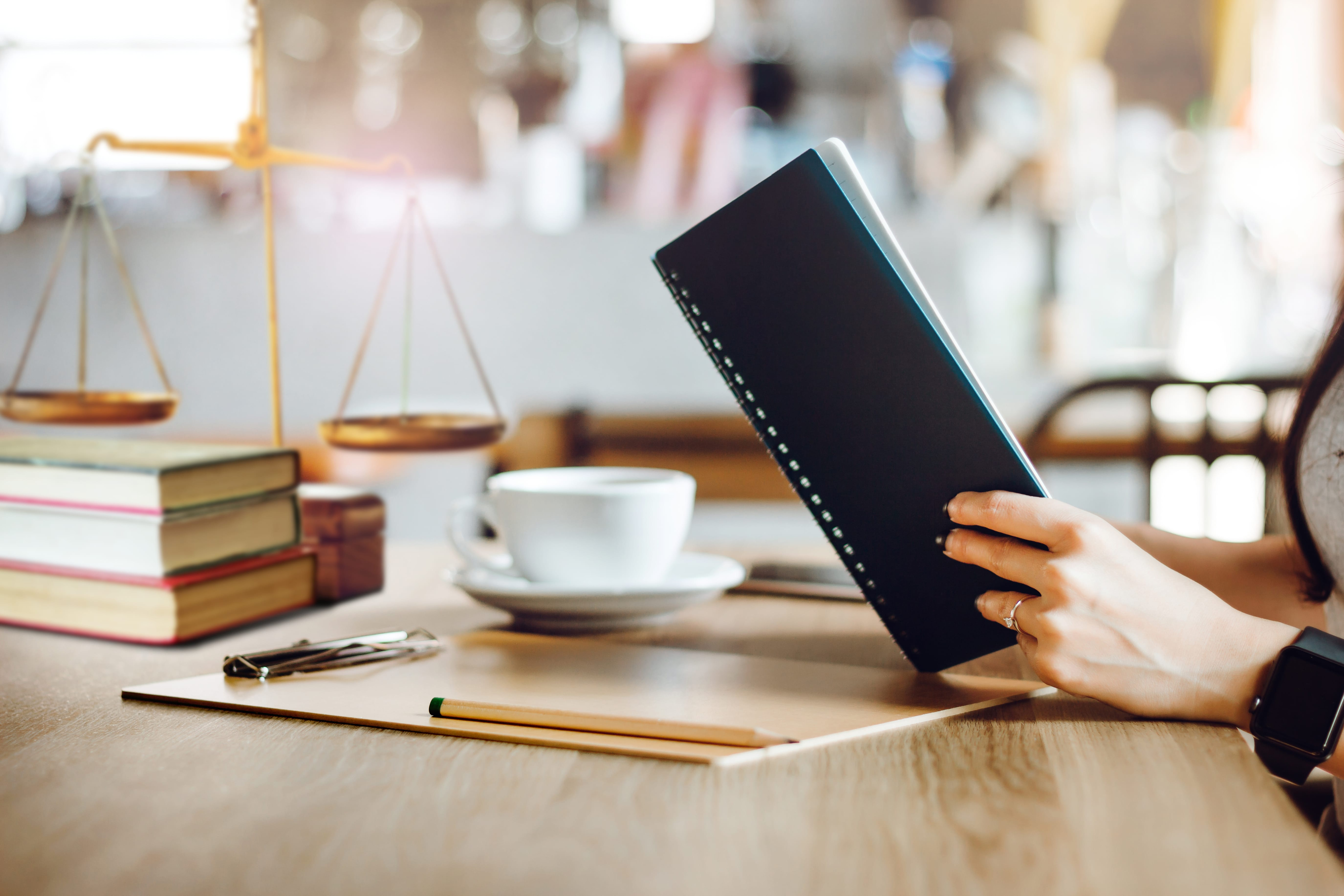 Female lawyer reading legal books while she working with on desk